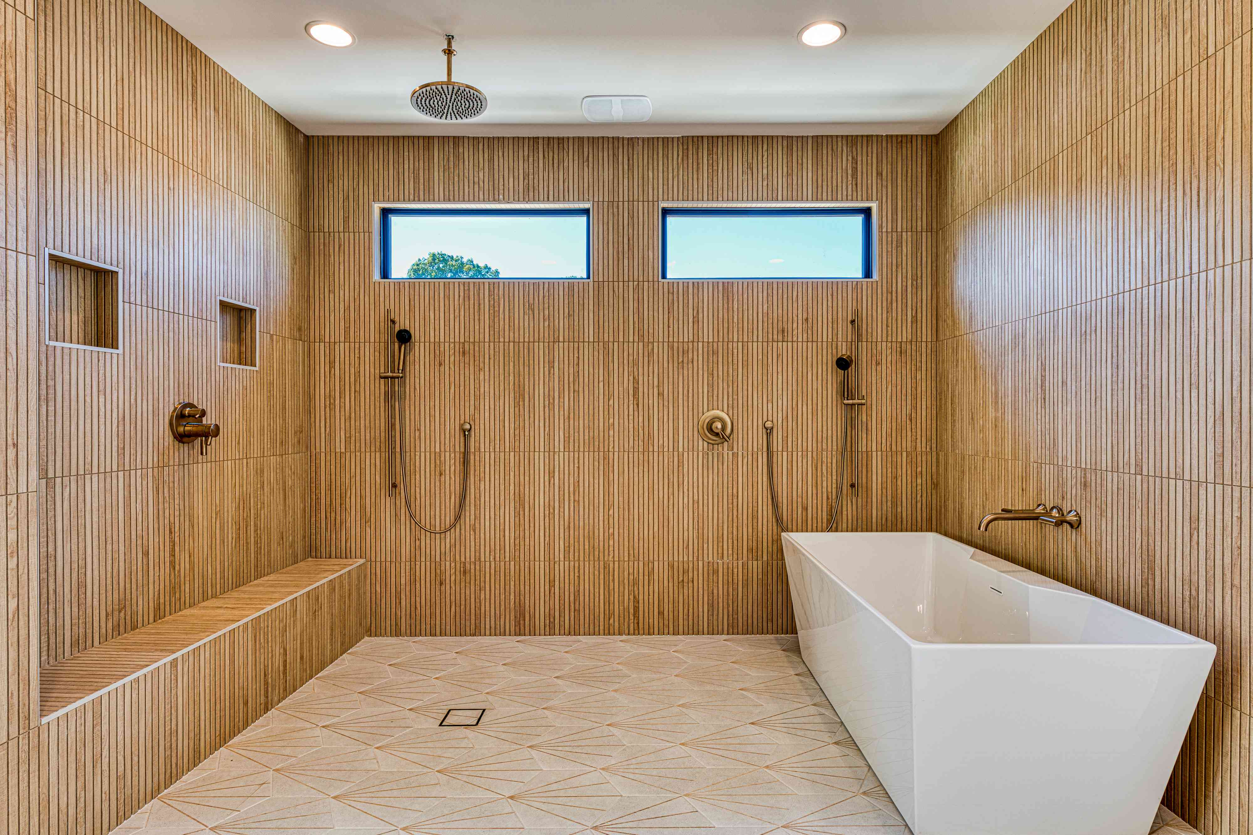 Primary bathroom with marble slab and freestanding tub by Shail Construction in Raleigh NC