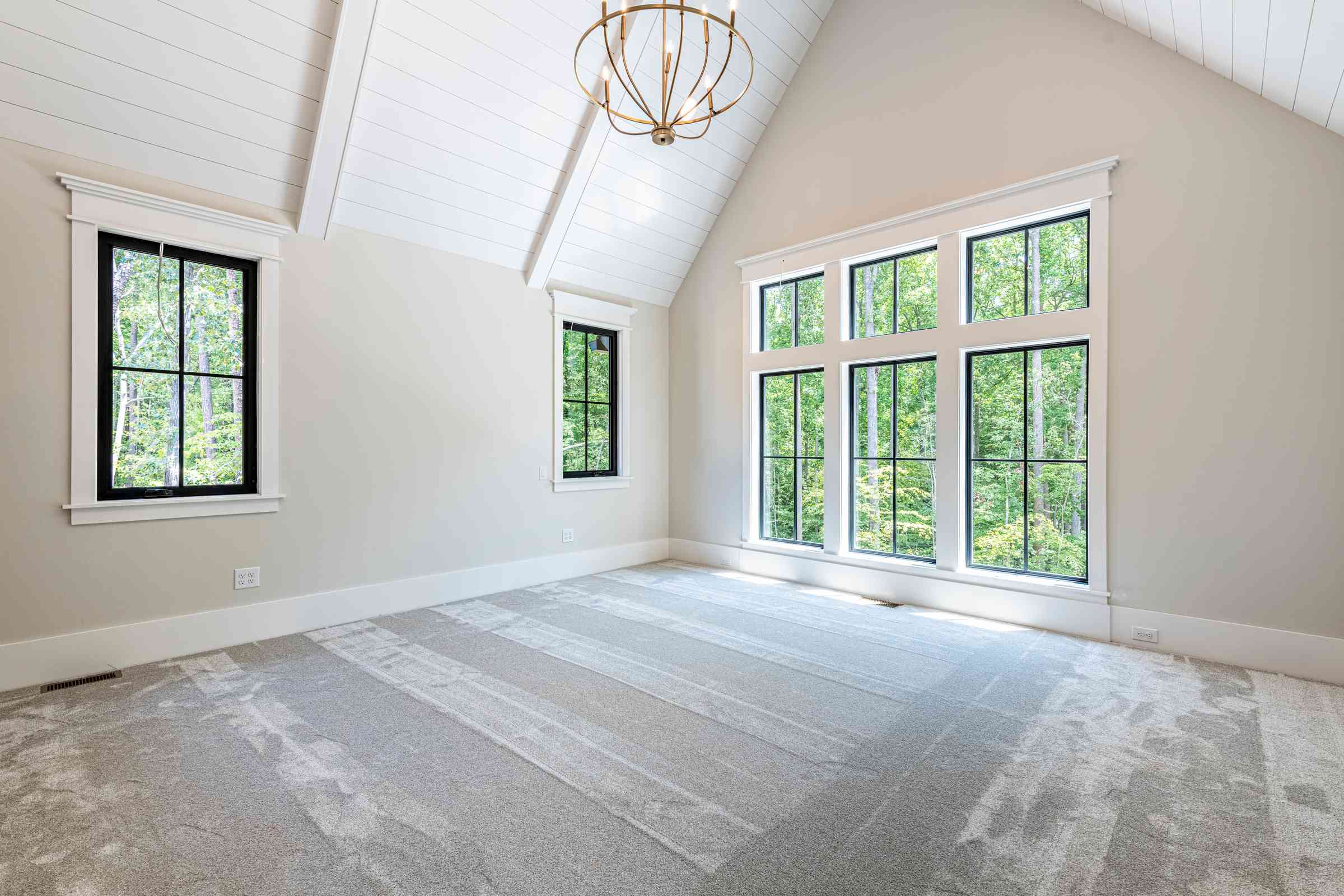 Primary bedroom with vaulted ceiling and fireplace by Shail Construction in Chapel Hill NC