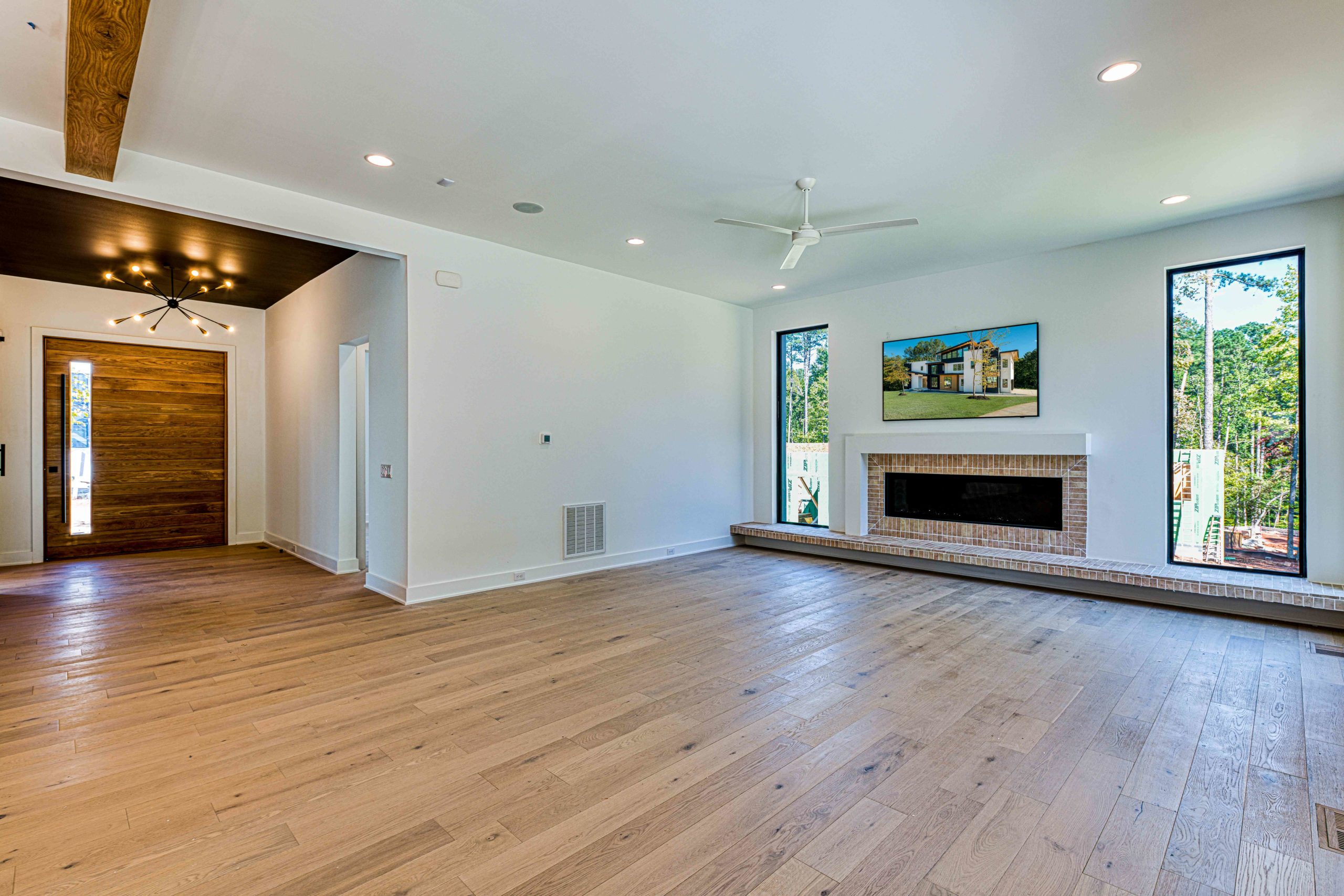 Beam ceiling great room with steel doors by Shail Construction in Raleigh NC