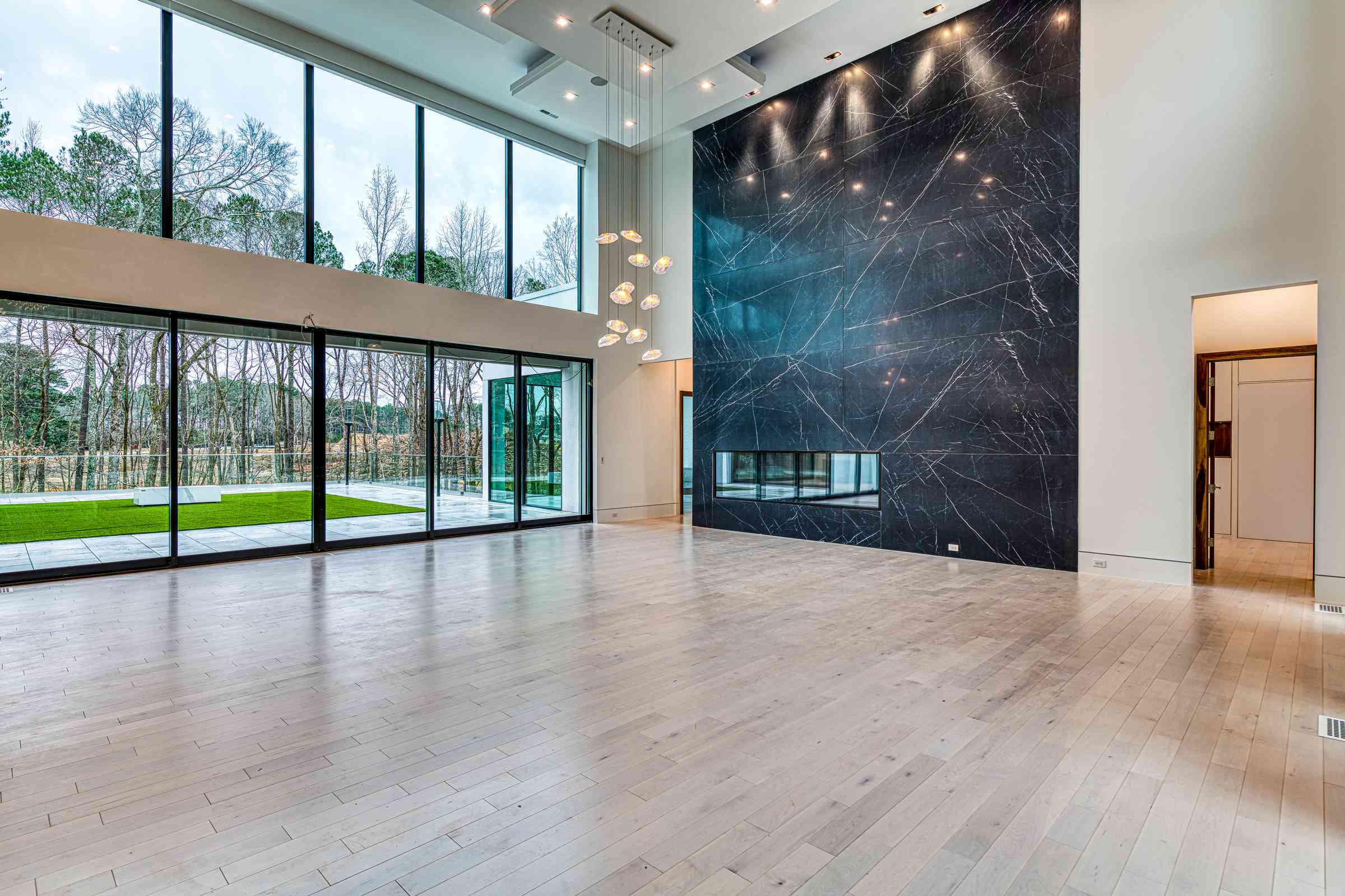 Great room with beam ceiling and custom built-ins by Shail Construction in Raleigh NC