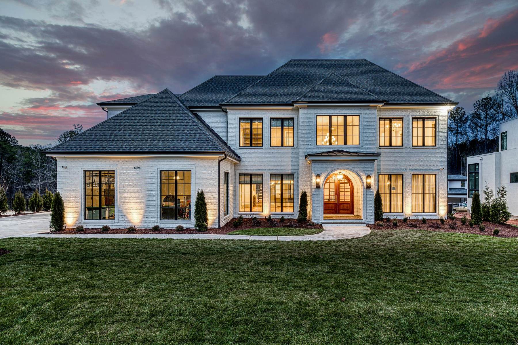 Traditional luxury estate exterior at dusk by Shail Construction in Raleigh NC