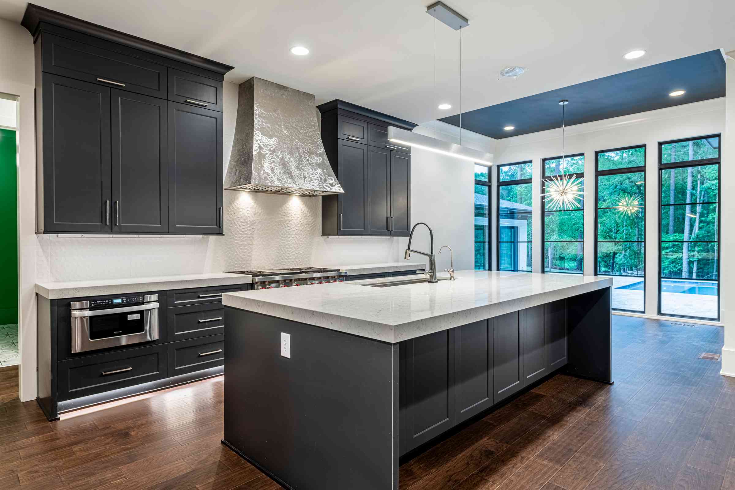 Custom chef's kitchen with statement range hood by Shail Construction in Cary NC