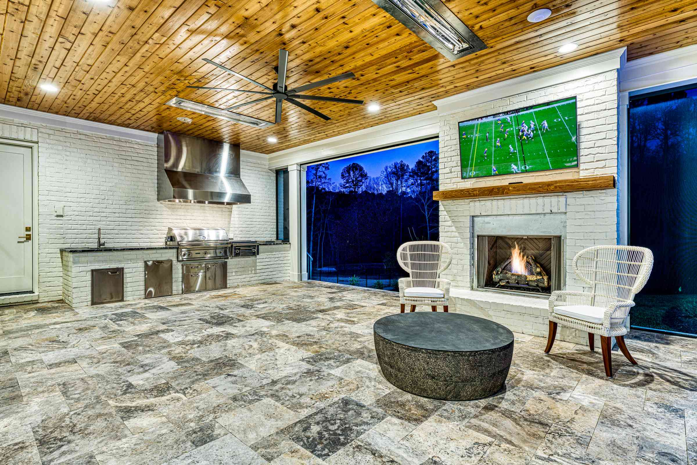 Twilight veranda with outdoor TV and fireplace by Shail Construction in Raleigh NC
