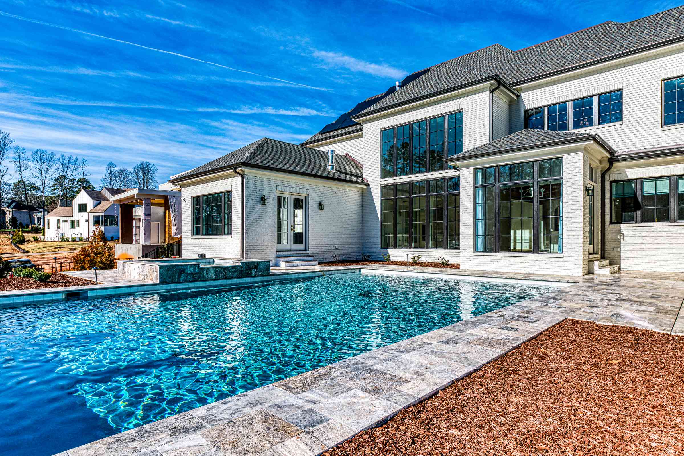 Resort-style swimming pool with stone surround by Shail Construction in Raleigh NC