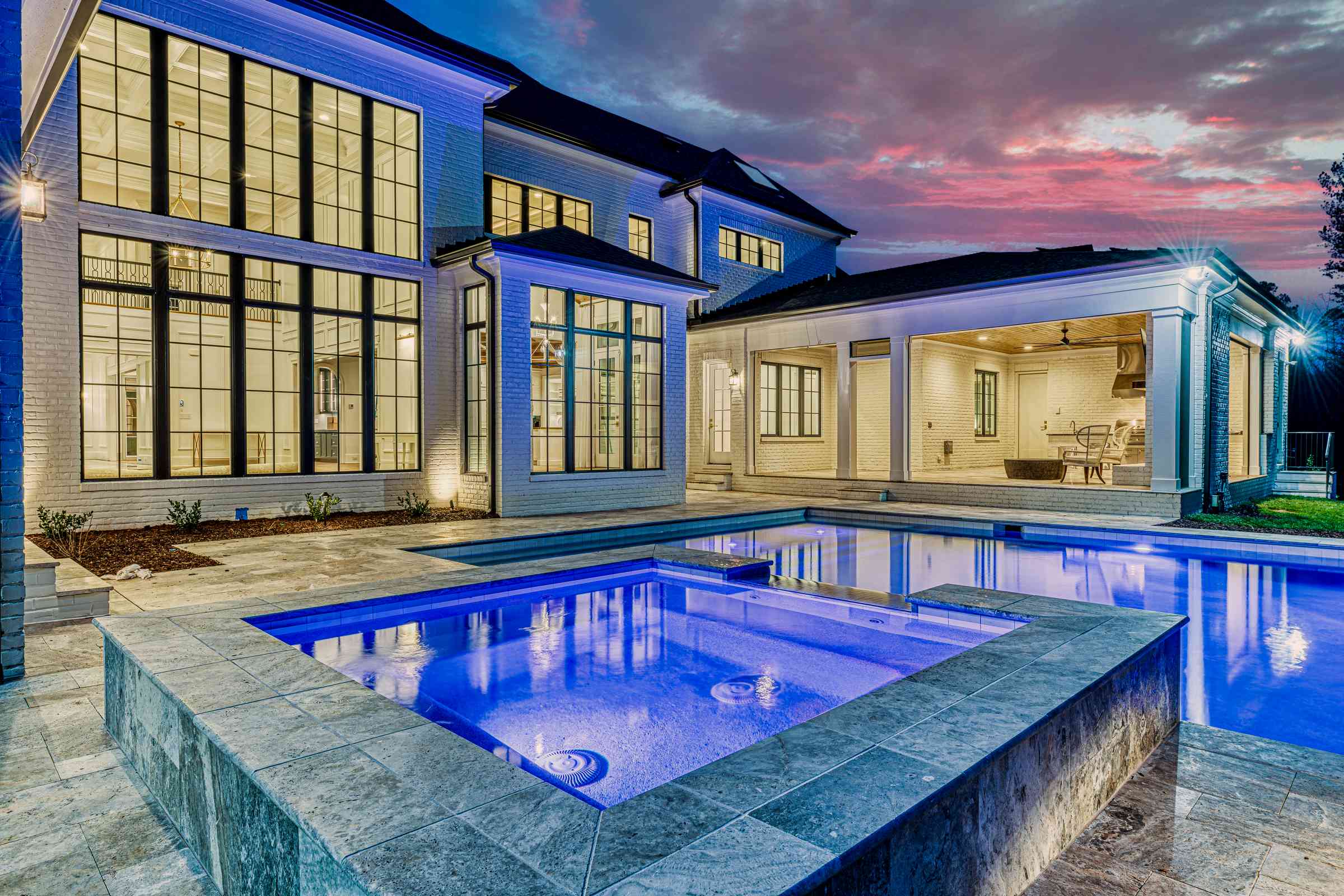 Twilight pool with feature lighting by Shail Construction in Raleigh NC