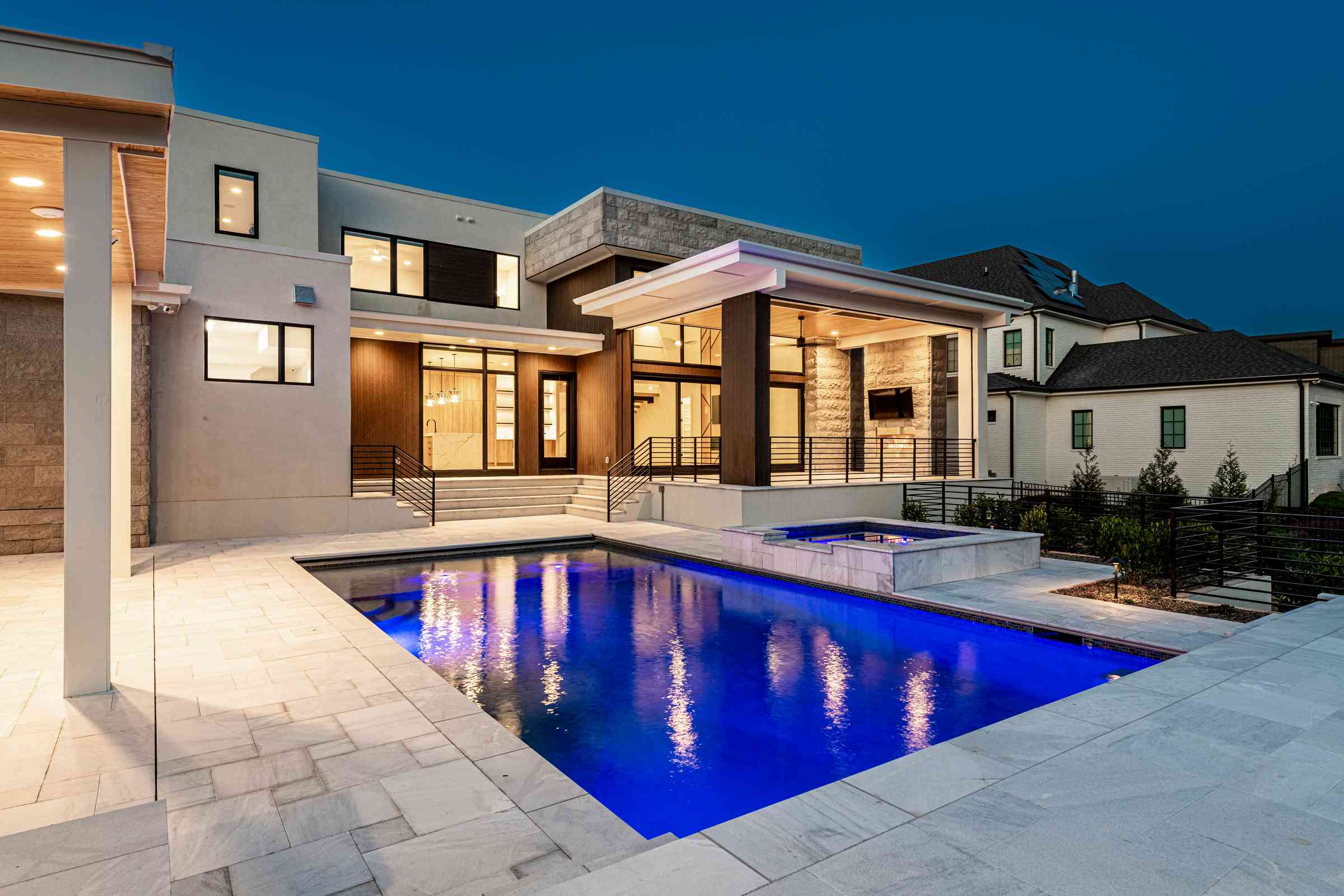 Twilight pool with linear water features by Shail Construction in Cary NC