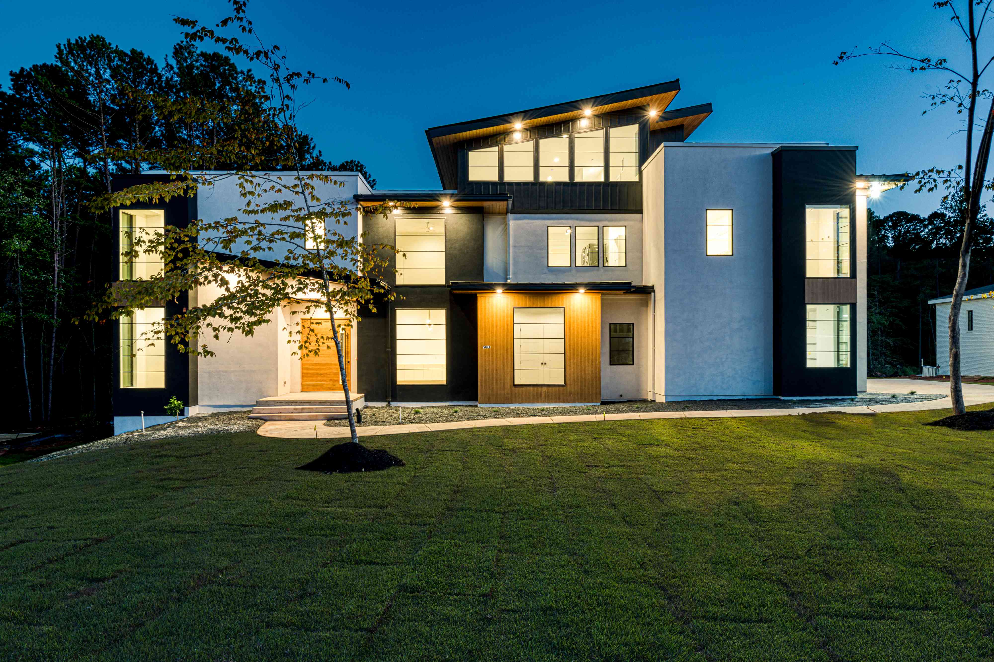 Twilight front exterior of a custom home by Shail Construction in Raleigh NC